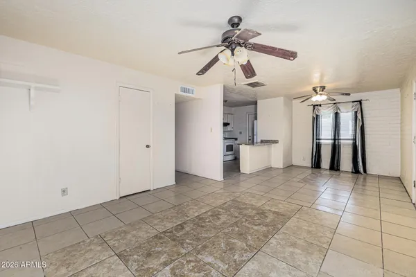 a view of a kitchen with a refrigerator and a ceiling fan