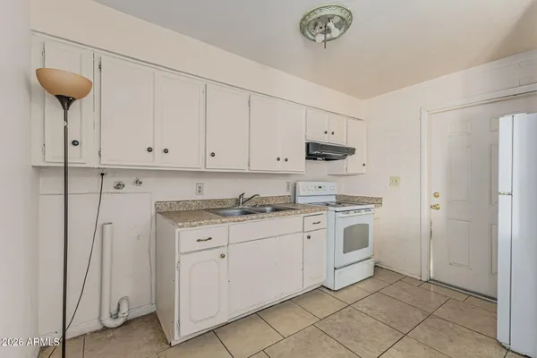 a kitchen with stainless steel appliances a stove a sink and cabinets