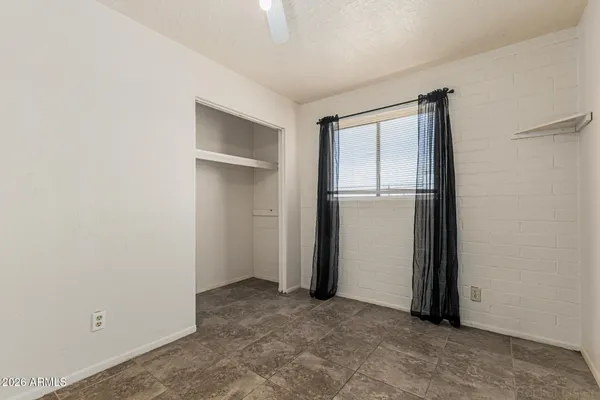 an empty room with closet area
