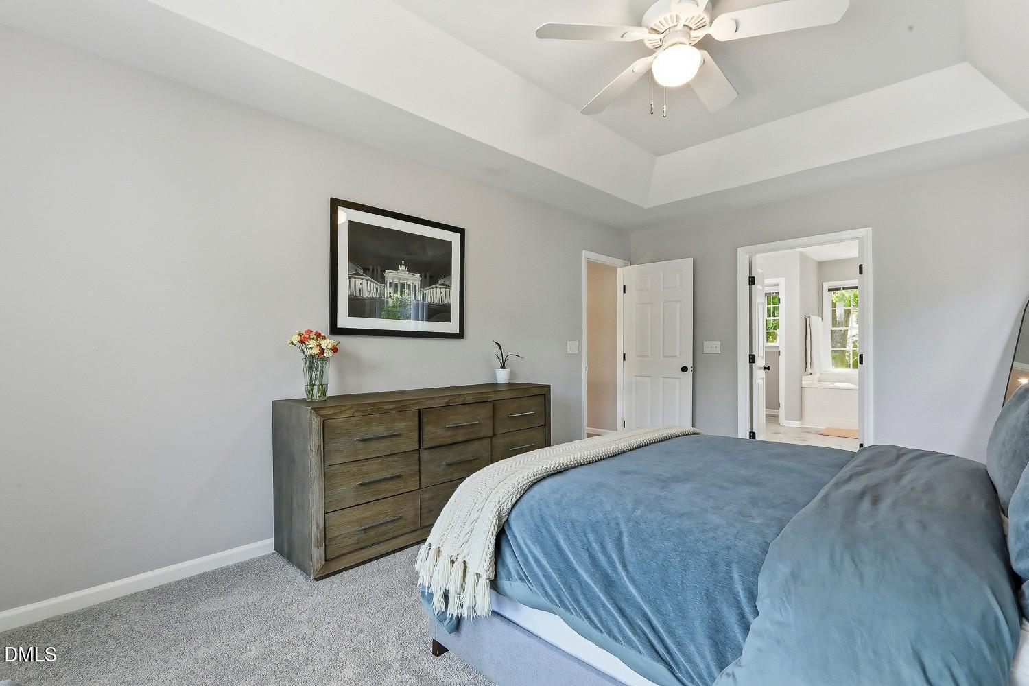 4001 Batiste Road Raleigh, NC 27613 - Photo 30 of 63 a bedroom with a bed and a chandelier