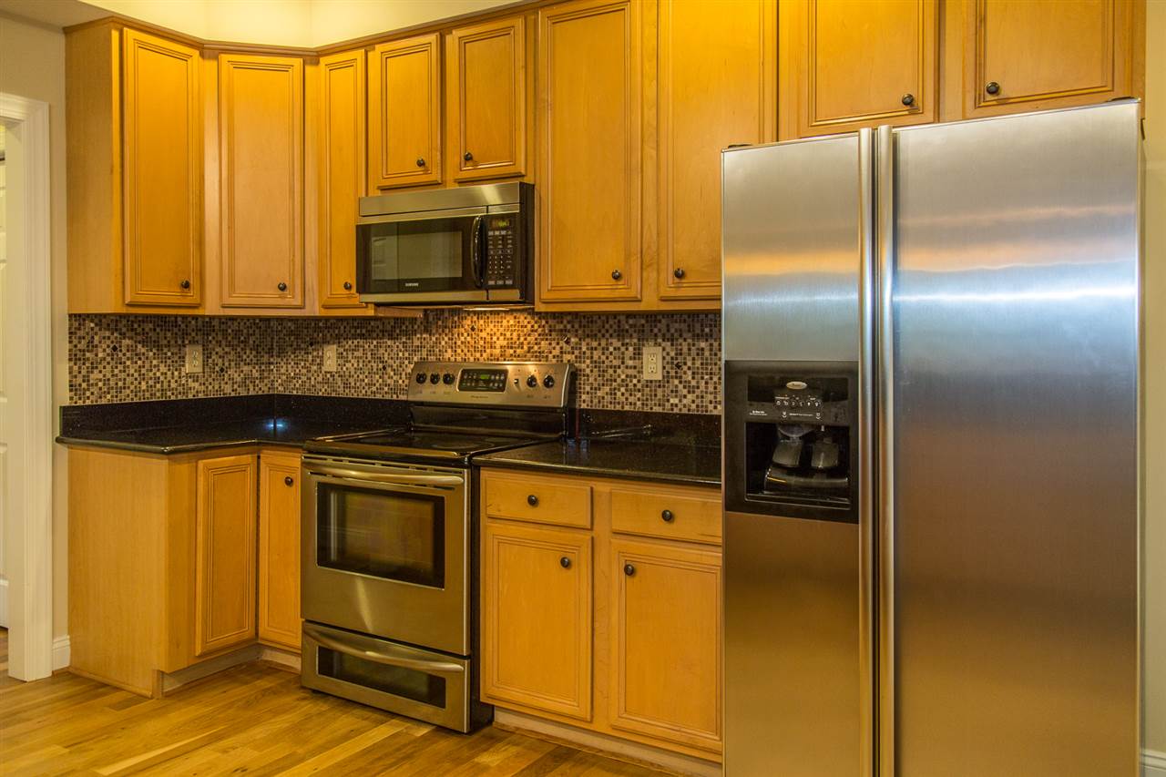 72 Willow Way Road Barboursville, VA 22923 - Photo 13 of 50 Cafe Imperial granite countertops, tile backsplash, cherry cabinets and stainless steel appliances.. Plenty for storage. The glass top stove is over the double oven. Take note, the lower door is a true oven and not a warming or storage drawer.