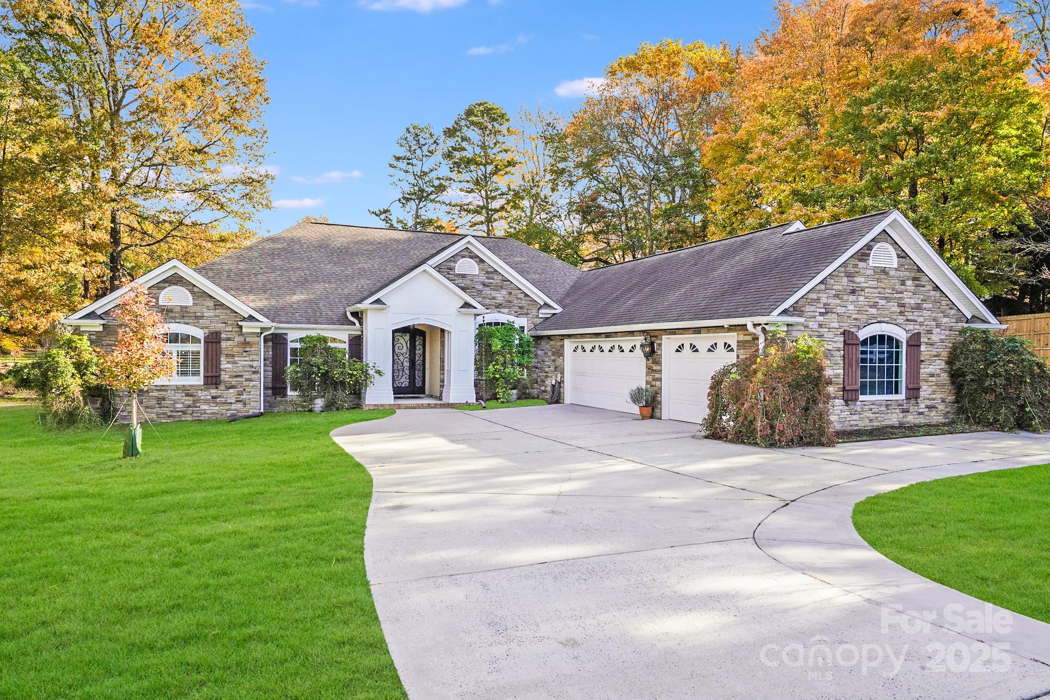 5329 Kuykendall Road Charlotte, NC 28270 - Photo 2 of 18 a front view of a house with a yard and garage