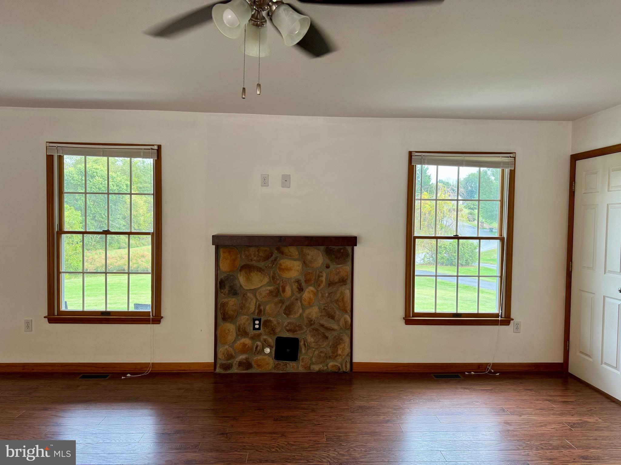 35 Coachman Drive Rising Sun, MD 21911 - Photo 17 of 58 an empty room with wooden floor and windows