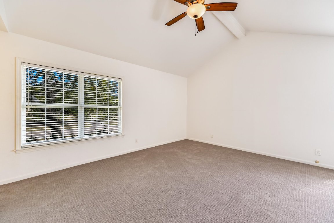 8806 El Rey Boulevard Austin, TX 78737 - Photo 13 of 35 Spare room with carpet flooring, a ceiling fan and window with natural light