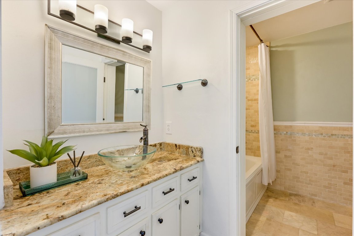 8806 El Rey Boulevard Austin, TX 78737 - Photo 15 of 35 Full bathroom with vanity, shower / bath tub combination and natural tile work