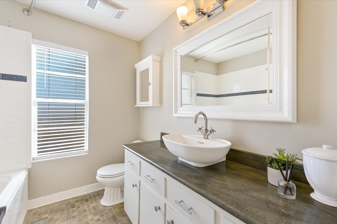 8806 El Rey Boulevard Austin, TX 78737 - Photo 17 of 35 Full bathroom featuring vanity, light tile patterned flooring, and shower/bathtub combination