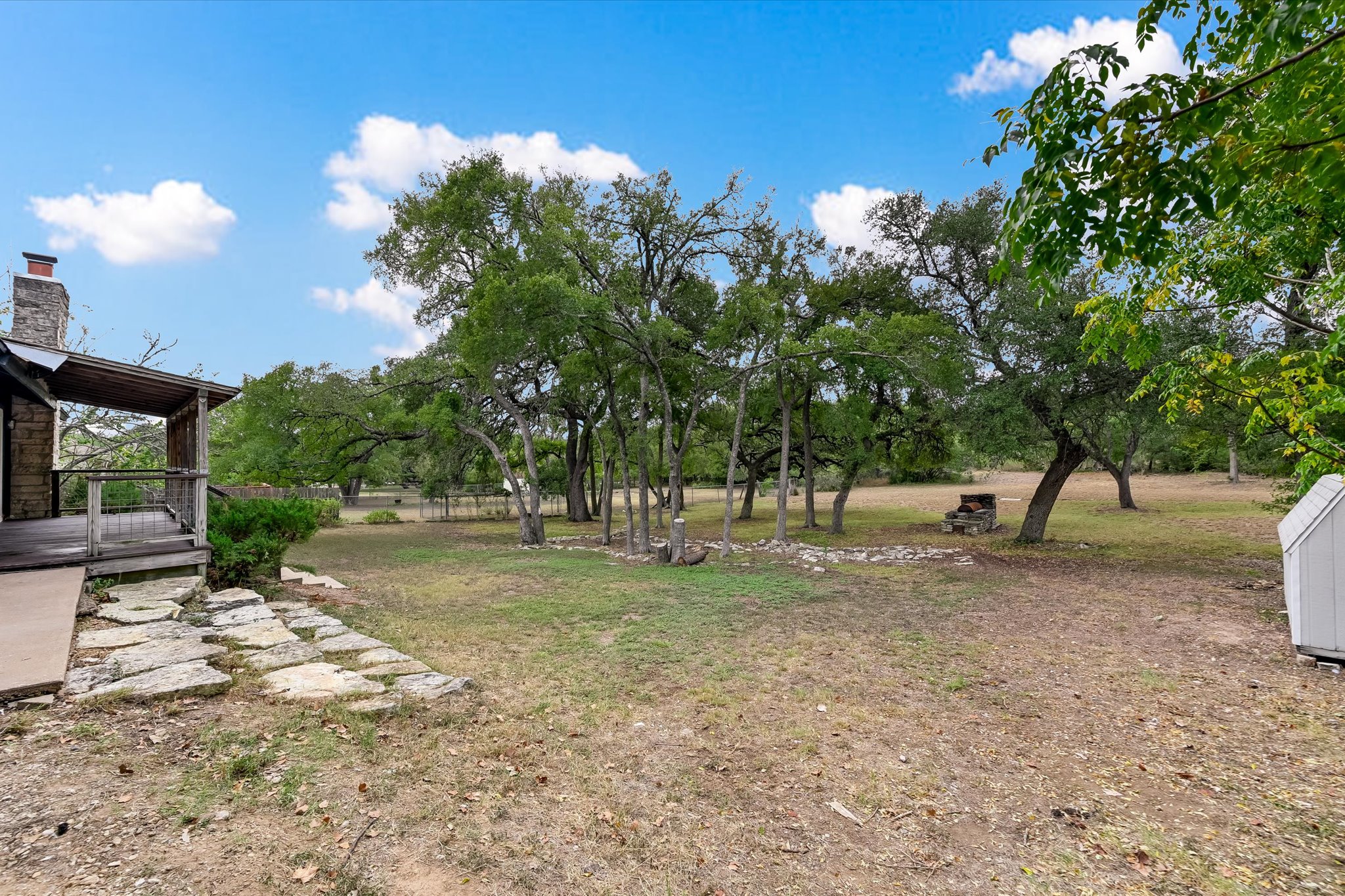 8806 El Rey Boulevard Austin, TX 78737 - Photo 22 of 38 a view of a tree in the middle of a yard