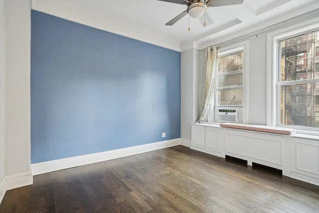 a bedroom with bed and a window