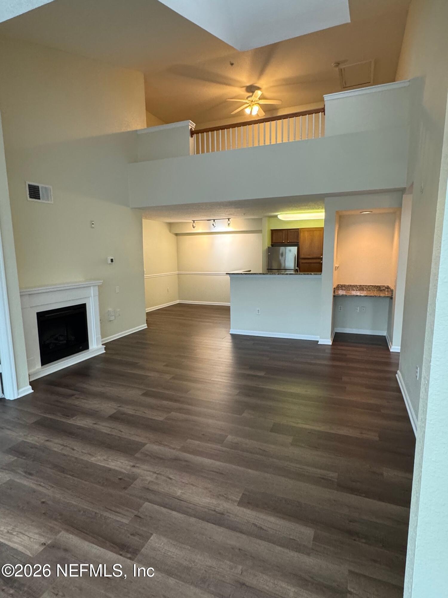 a view of a room with wooden floor