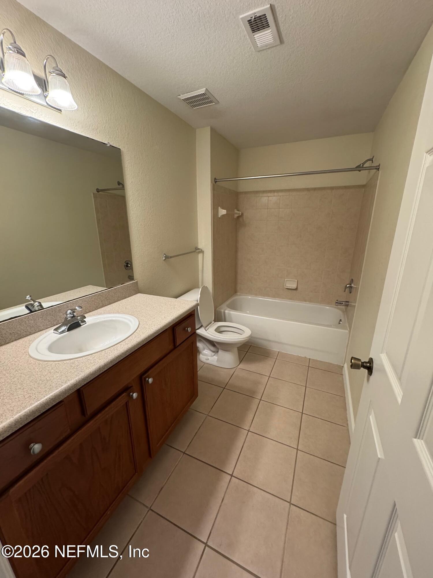 8550 Touchton Road, Unit 1727 Jacksonville, FL 32216 - Photo 13 of 15 a bathroom with a double vanity sink mirror and bathtub