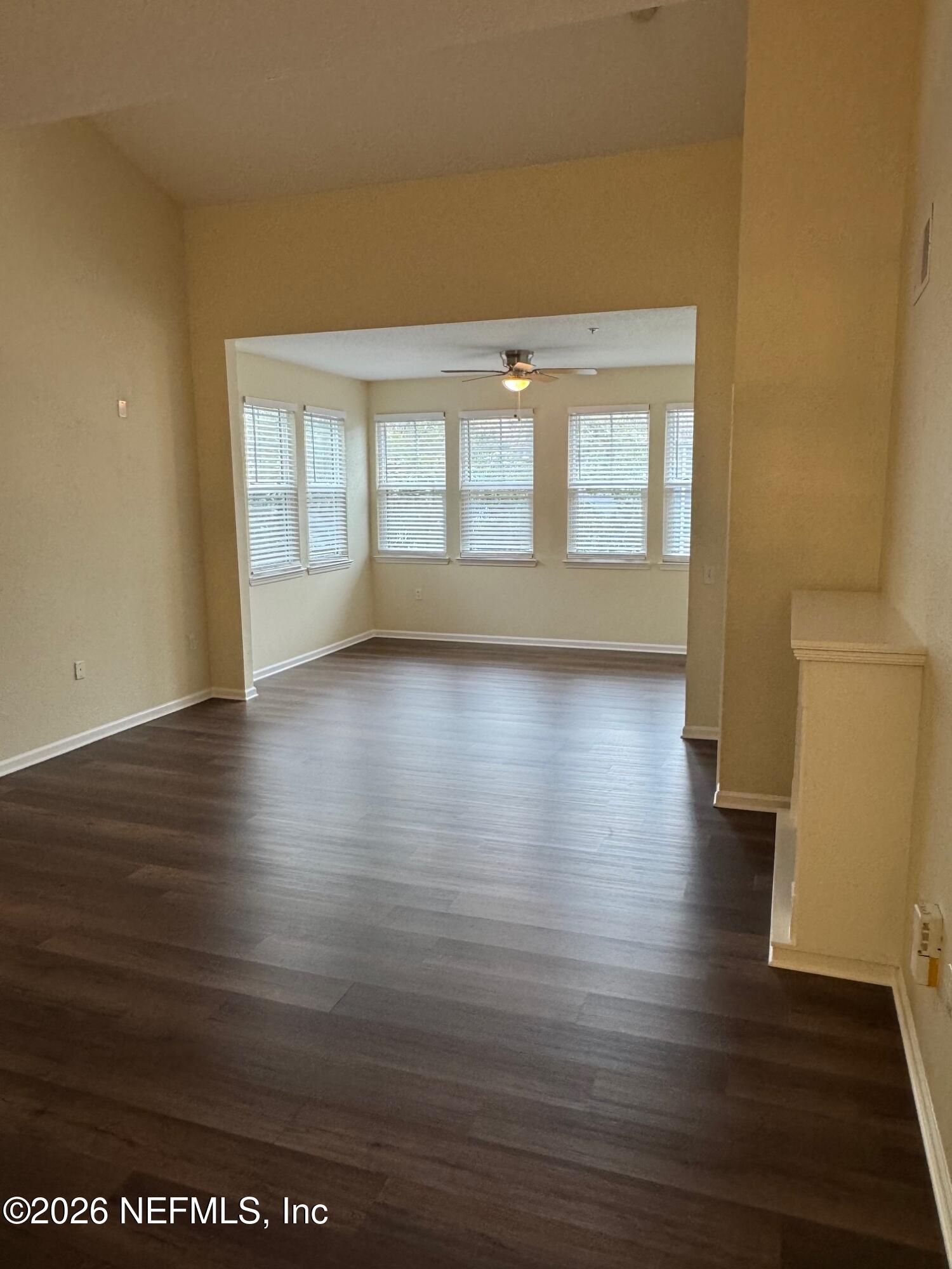 8550 Touchton Road, Unit 1727 Jacksonville, FL 32216 - Photo 4 of 15 a view of an empty room with wooden floor and a window