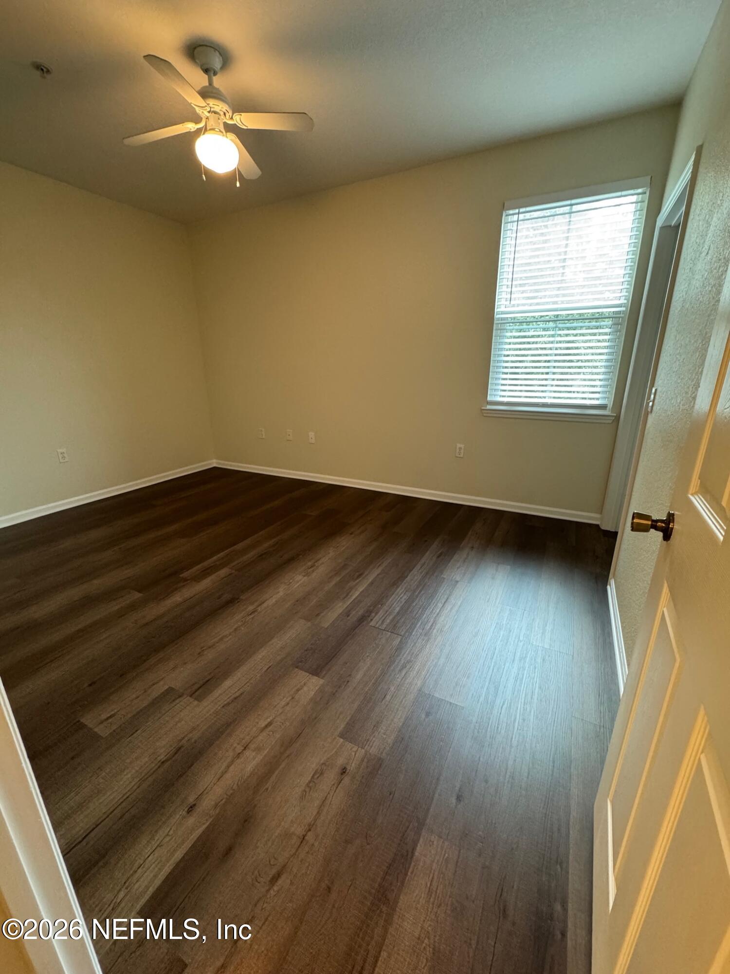 8550 Touchton Road, Unit 1727 Jacksonville, FL 32216 - Photo 9 of 15 wooden floor in an empty room with a window