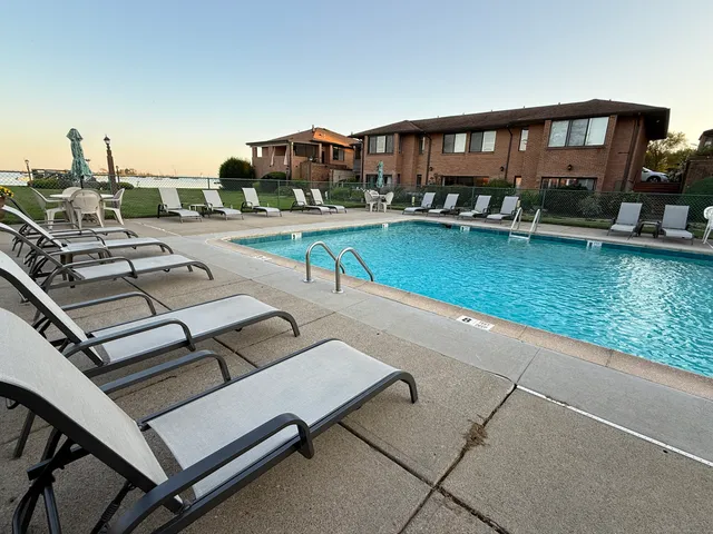 a view of a patio with chairs and a table