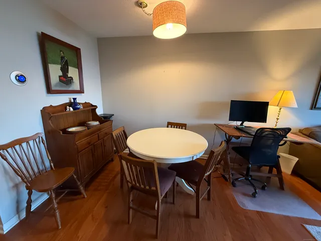 a view of a workspace with furniture and wooden floor