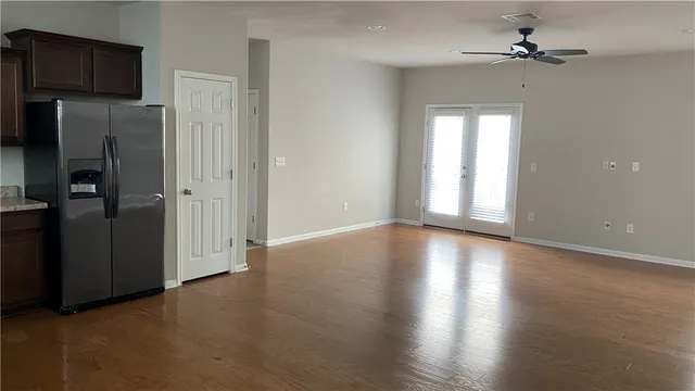 a kitchen with granite countertop a refrigerator and a sink