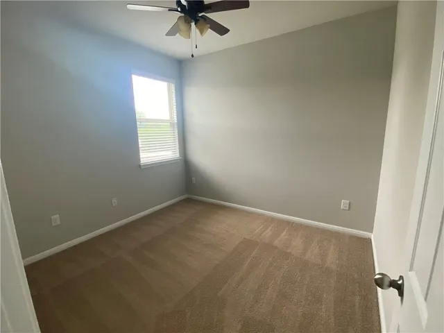 a view of a backyard with a house and wooden fence