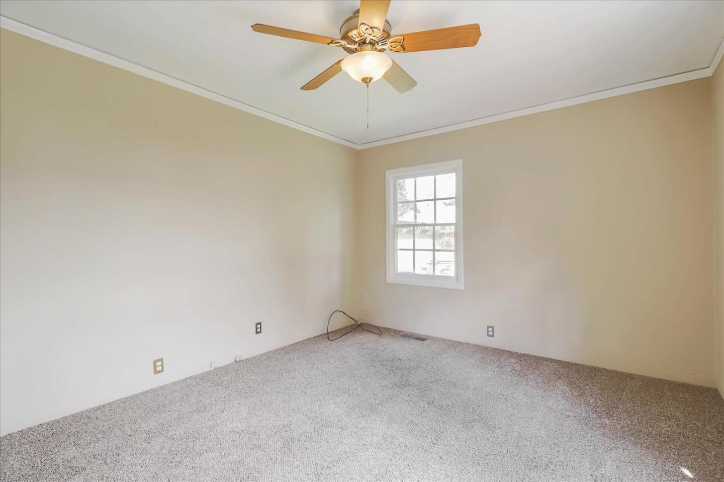 420 Sunset Boulevard Hayward, CA 94541 - Photo 21 of 51 an empty room with a window and a fan
