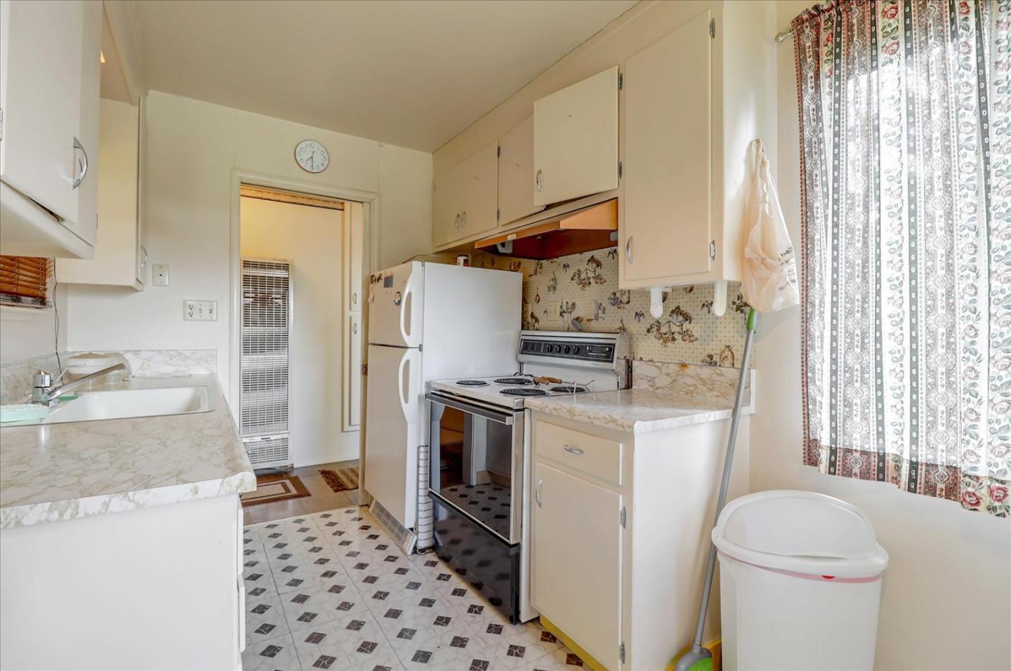 420 Sunset Boulevard Hayward, CA 94541 - Photo 38 of 51 a kitchen with a stove a refrigerator and a sink