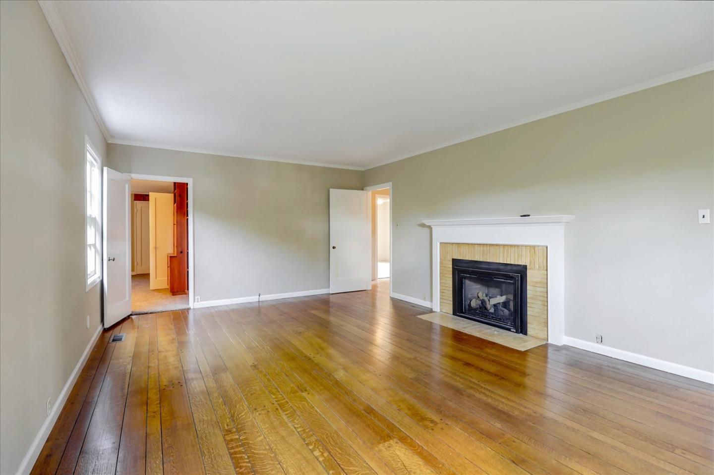 420 Sunset Boulevard Hayward, CA 94541 - Photo 5 of 51 a view of an empty room with wooden floor fireplace and a window