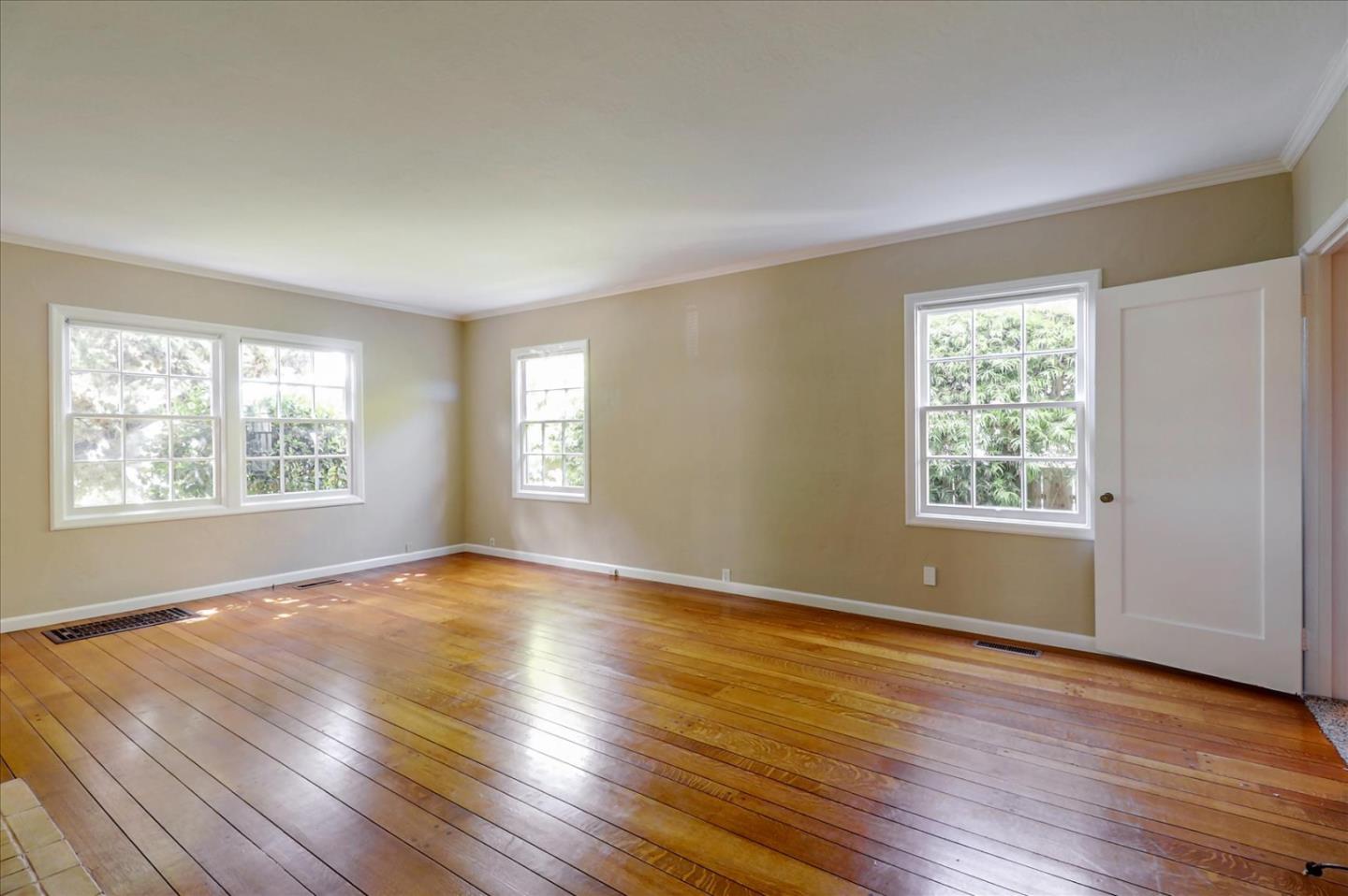 420 Sunset Boulevard Hayward, CA 94541 - Photo 7 of 51 an empty room with wooden floor and windows