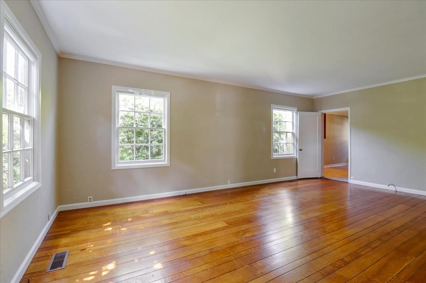 420 Sunset Boulevard Hayward, CA 94541 - Photo 8 of 51 a view of an empty room with wooden floor and a window