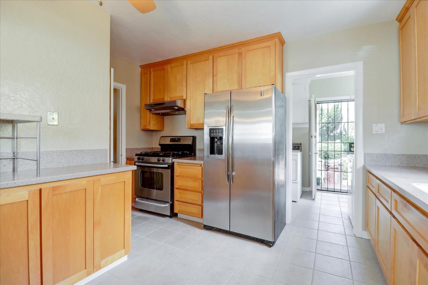 420 Sunset Boulevard Hayward, CA 94541 - Photo 9 of 51 a kitchen with stainless steel appliances granite countertop a refrigerator and a stove