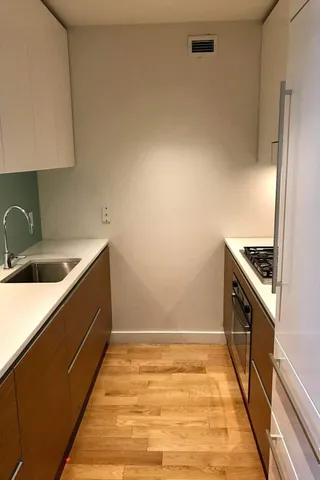 a kitchen with a sink stove and cabinets