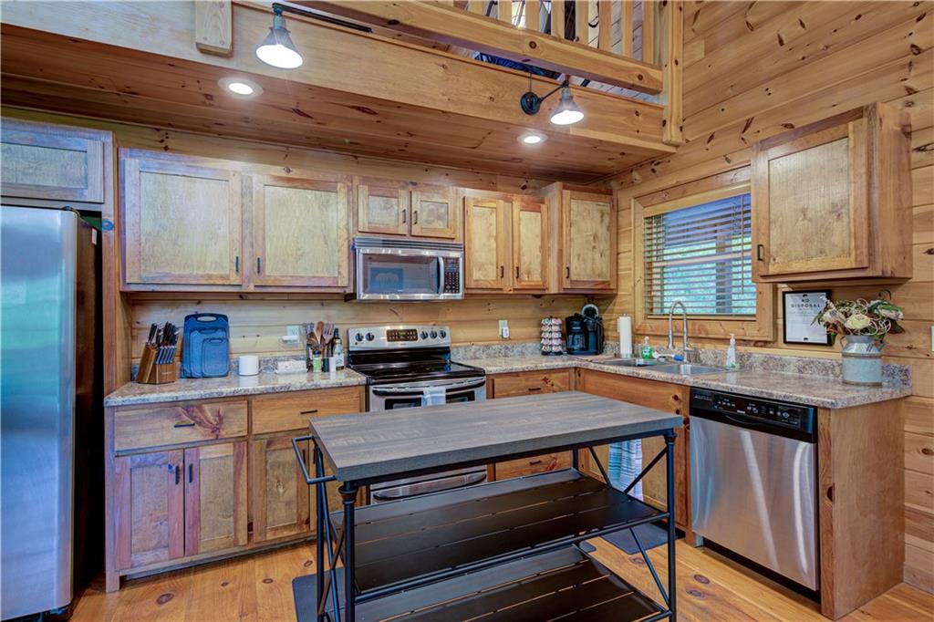 774 Kelly Ridge Drive Blue Ridge, GA 30513 - Photo 27 of 99 a kitchen with stainless steel appliances a stove a sink cabinets and a refrigerator