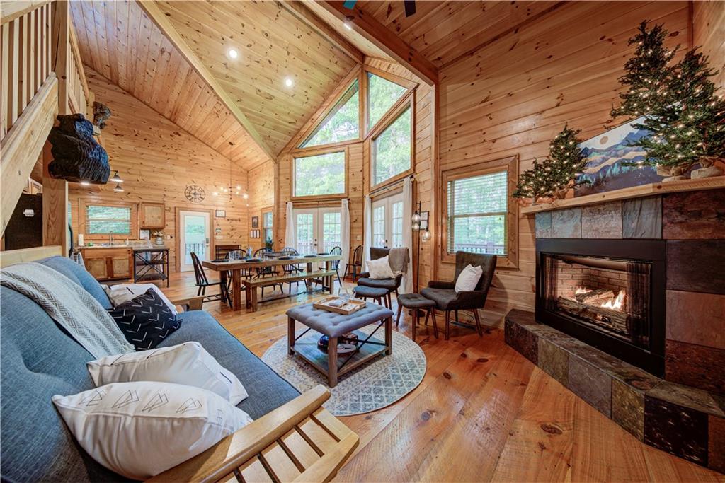 774 Kelly Ridge Drive Blue Ridge, GA 30513 - Photo 3 of 99 a living room with furniture a fireplace a flat screen tv and floor to ceiling window