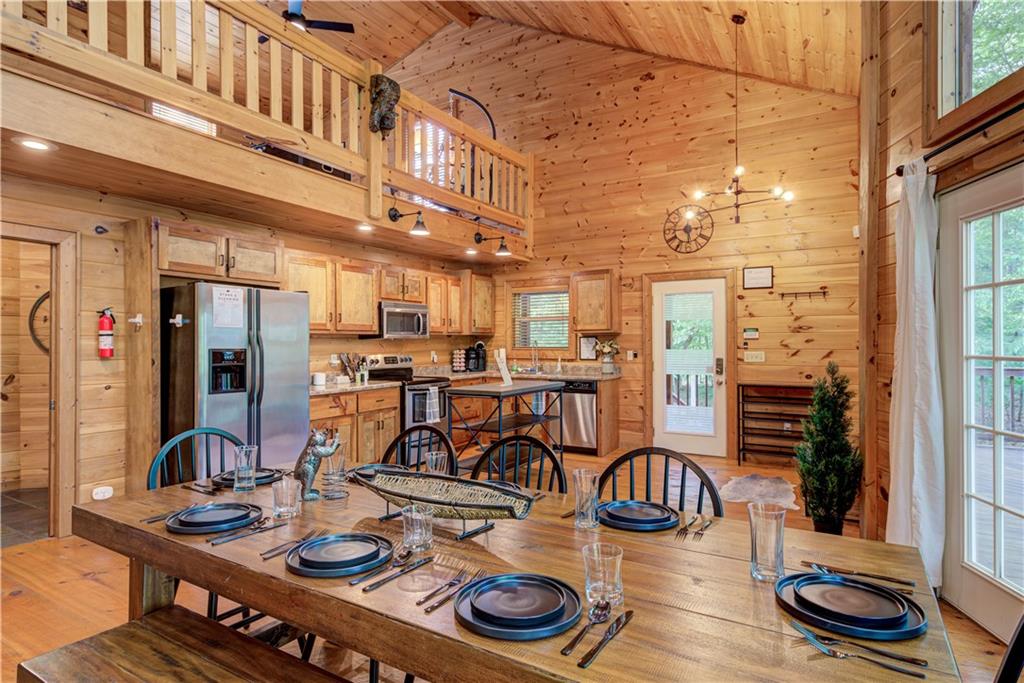 774 Kelly Ridge Drive Blue Ridge, GA 30513 - Photo 32 of 99 a kitchen with stainless steel appliances kitchen island granite countertop a table chairs and a stove