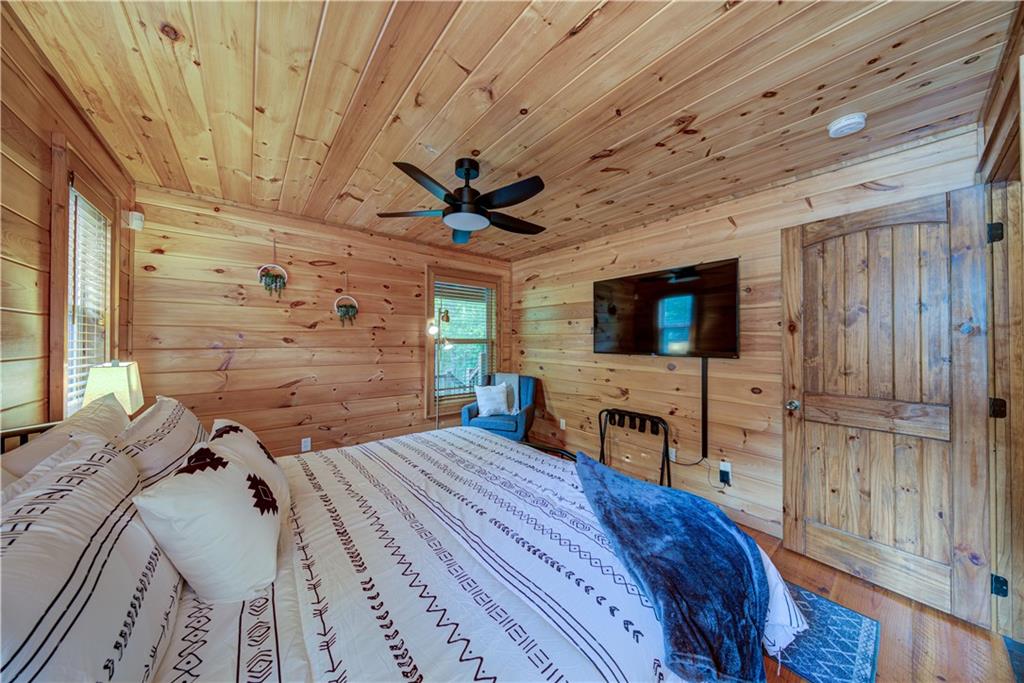 774 Kelly Ridge Drive Blue Ridge, GA 30513 - Photo 39 of 99 a bedroom with a bed and a flat screen tv