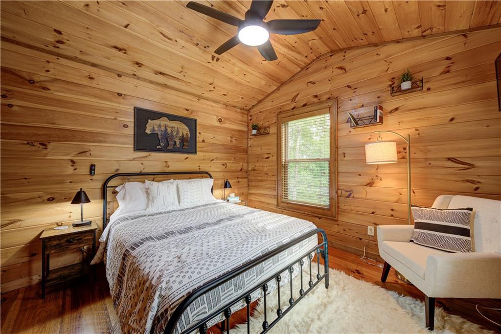 774 Kelly Ridge Drive Blue Ridge, GA 30513 - Photo 5 of 99 a bedroom with a bed next to a window and a flat screen tv