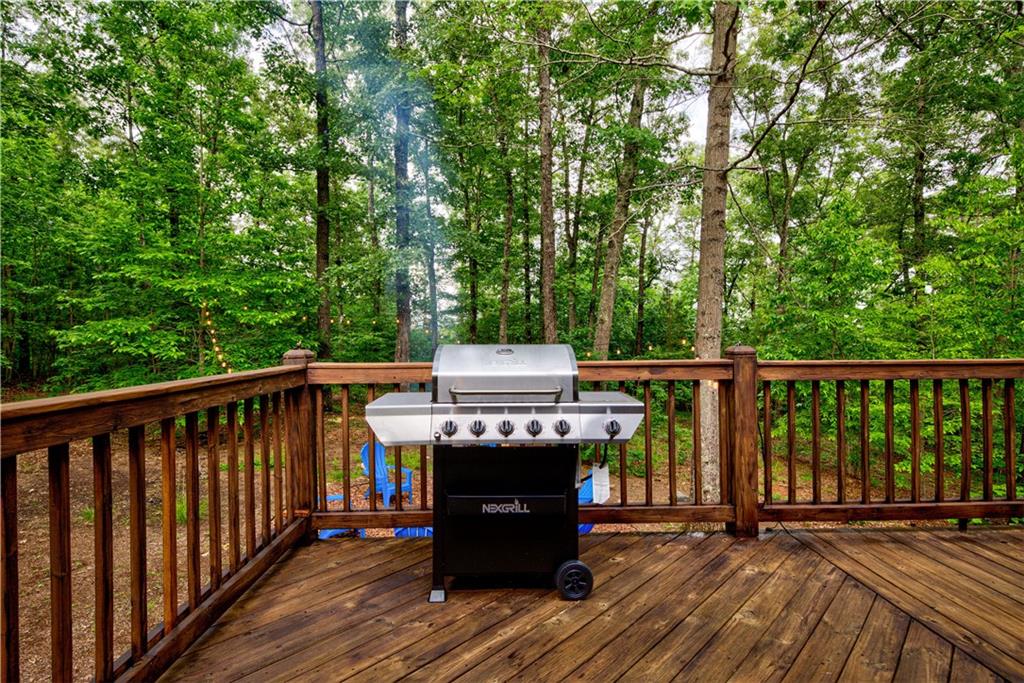 774 Kelly Ridge Drive Blue Ridge, GA 30513 - Photo 65 of 99 a view of a deck with wooden floor barbeque oven and trees in the back