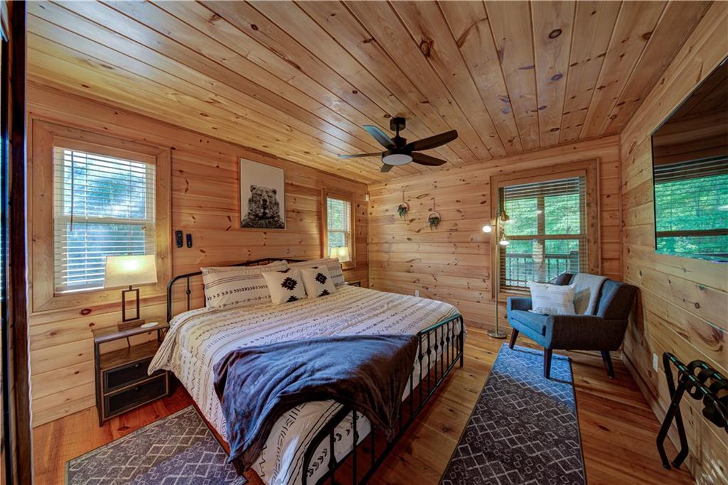 774 Kelly Ridge Drive Blue Ridge, GA 30513 - Photo 8 of 99 a bedroom with a bed a flat screen tv and a large window