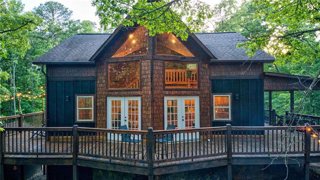 774 Kelly Ridge Drive Blue Ridge, GA 30513 - Photo 91 of 99 a view of a brick house with a deck and furniture