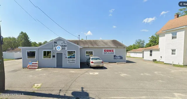 a front view of a house with a parking lot