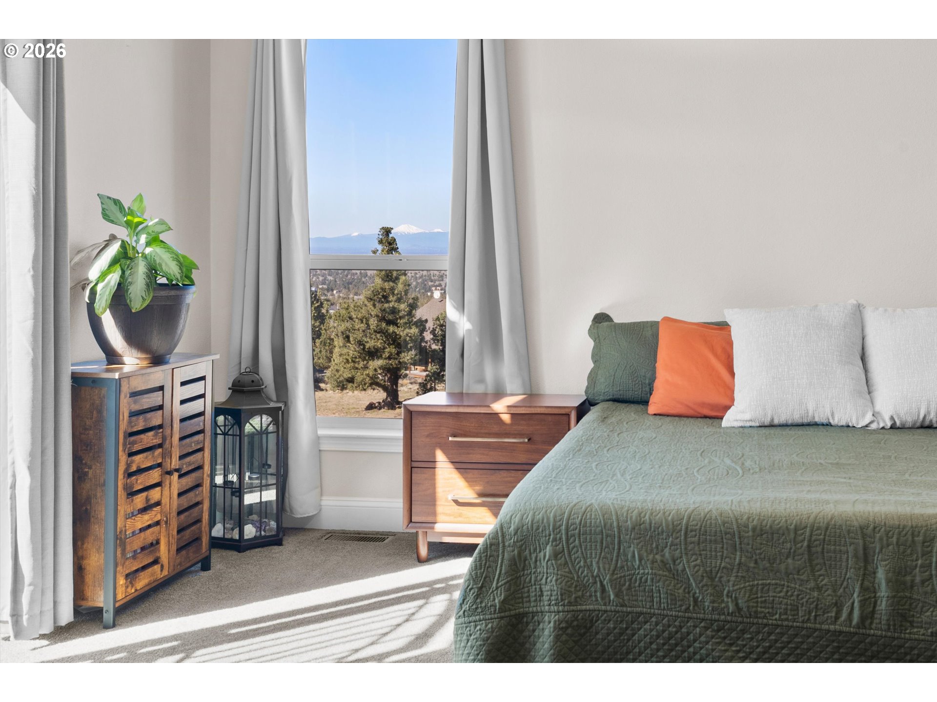 5172 Southeast Oswego Road Prineville, OR 97754 - Photo 26 of 48 a bedroom with a bed table and a potted plant