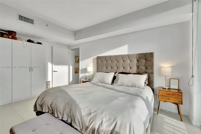 a large bed sitting in a bedroom and a table