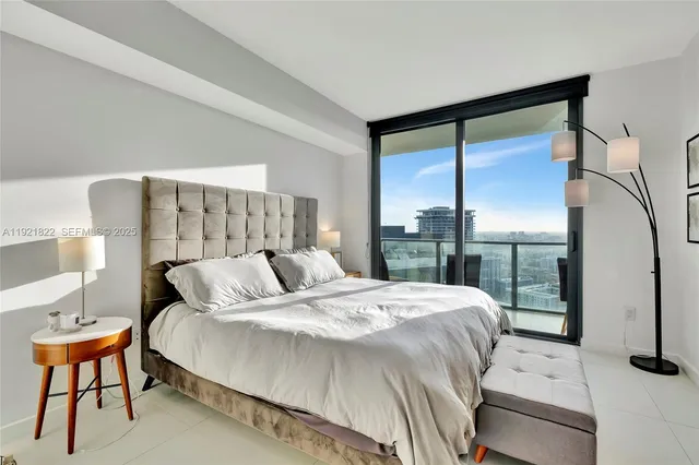 a bedroom with a bed and a night stand