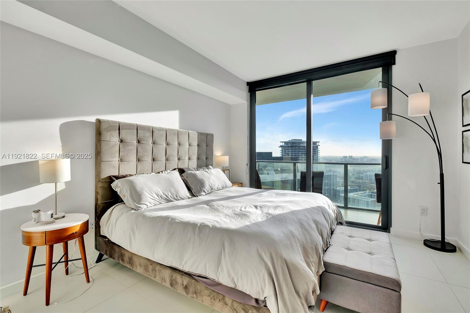 501 Northeast 31st Street, Unit 3708 Miami, FL 33137 - Photo 19 of 31 a bedroom with a bed and a night stand