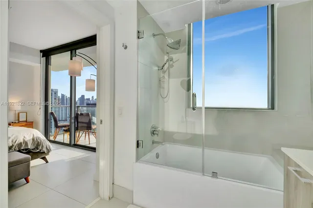 a bathroom with a tub and shower