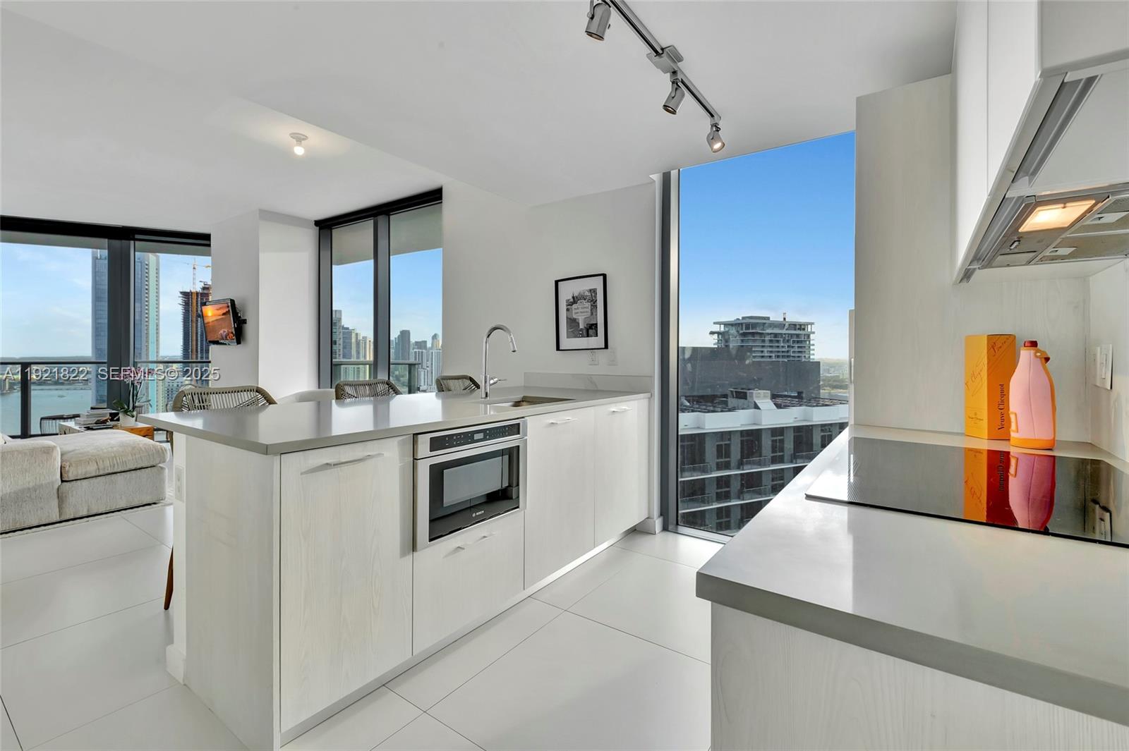 501 Northeast 31st Street, Unit 3708 Miami, FL 33137 - Photo 8 of 31 a kitchen that has a lot of white cabinets and stainless steel appliances