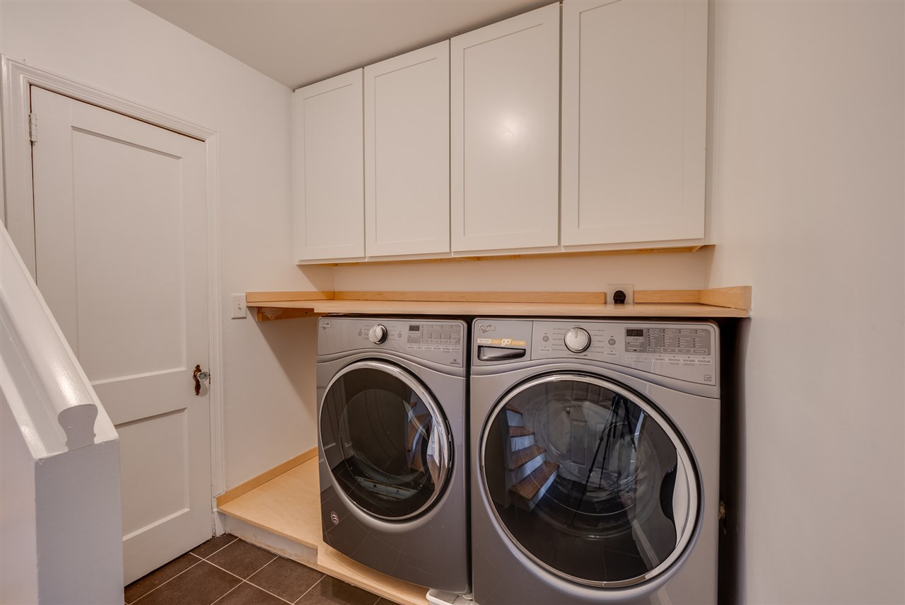 703 Kimbrough Street Raleigh, NC 27608 - Photo 19 of 25 Separate laundry area with storage for all your cleaning needs! Laundry
