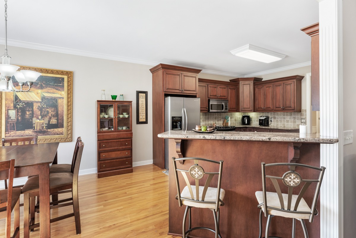 105 Robin Point Gallatin, TN 37066 - Photo 20 of 59 a kitchen with stainless steel appliances granite countertop a dining table chairs refrigerator and sink