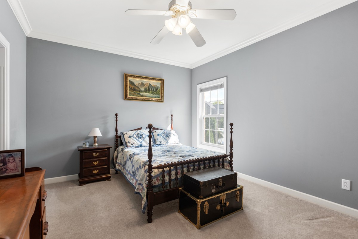 105 Robin Point Gallatin, TN 37066 - Photo 40 of 59 a bedroom with a bed and a chandelier