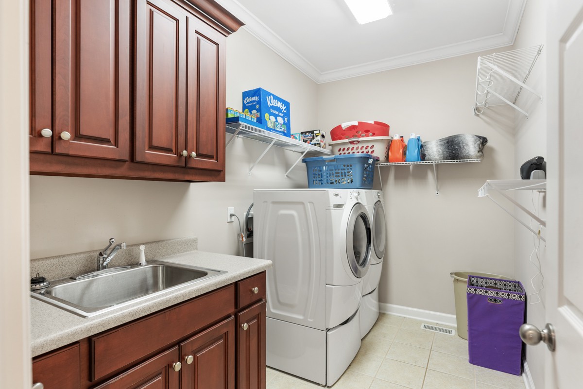 105 Robin Point Gallatin, TN 37066 - Photo 41 of 59 a utility room with cabinets washer and dryer