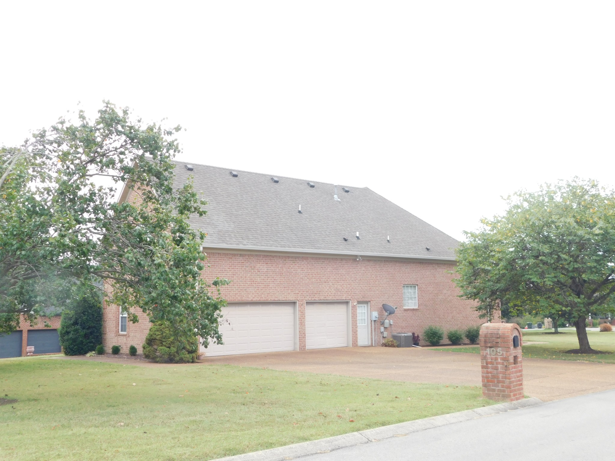 105 Robin Point Gallatin, TN 37066 - Photo 7 of 59 a front view of a house with a garden and yard