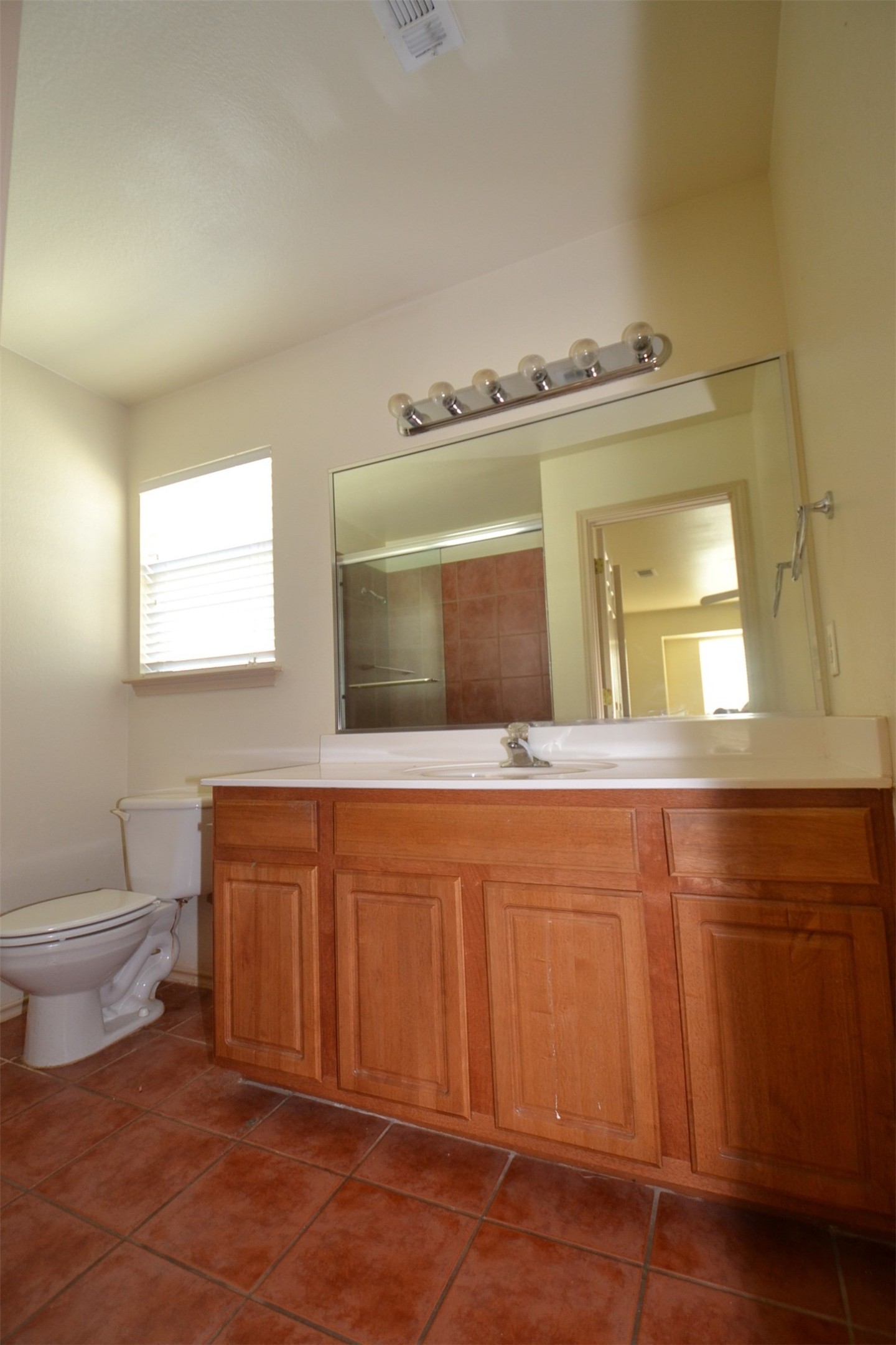 6912 Meador Avenue, Unit A Austin, TX 78752 - Photo 10 of 22 Full bathroom with vanity, dark tile patterned floors, and a shower