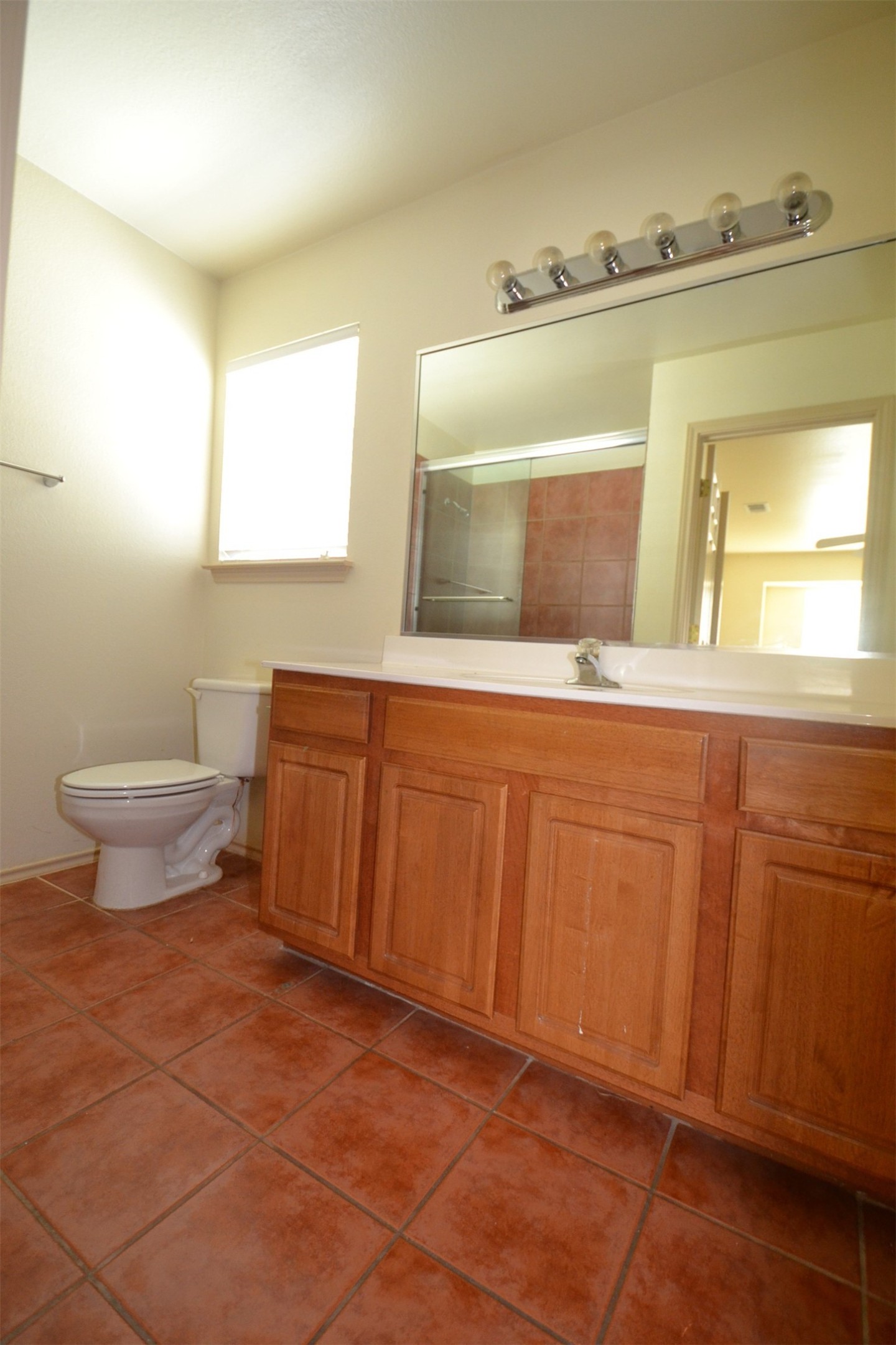 6912 Meador Avenue, Unit A Austin, TX 78752 - Photo 11 of 22 Full bath with vanity, dark tile patterned floors, and a shower