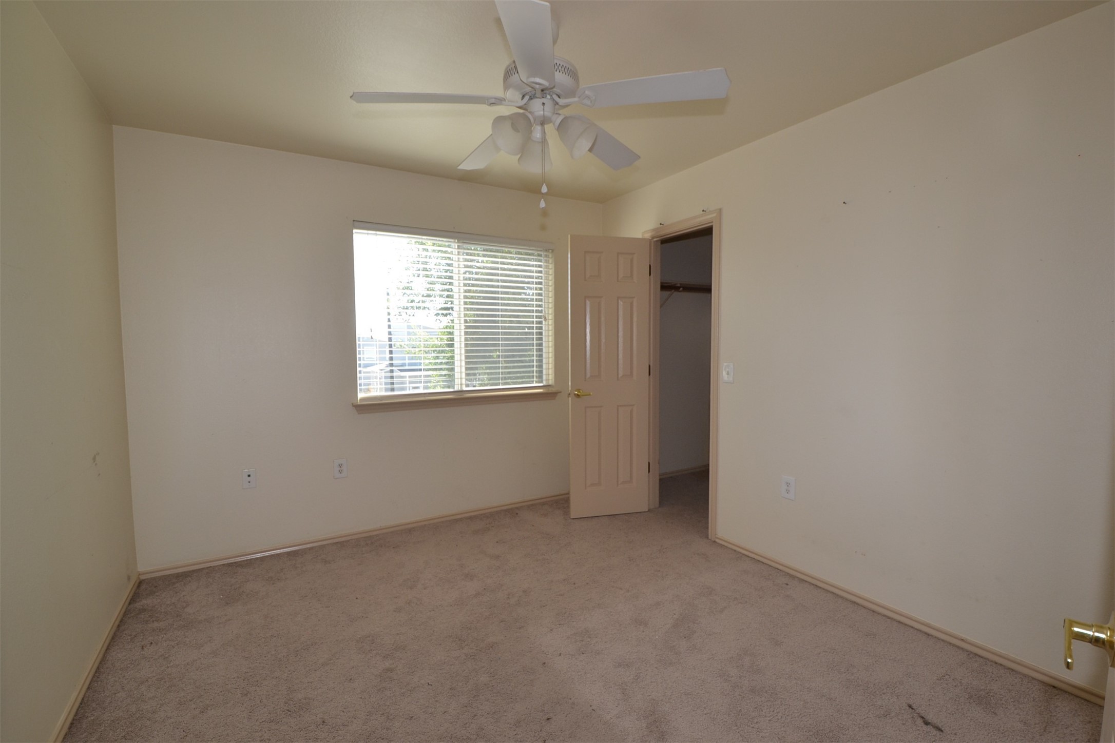 6912 Meador Avenue, Unit A Austin, TX 78752 - Photo 12 of 22 Unfurnished bedroom featuring a walk in closet, light colored carpet, and ceiling fan